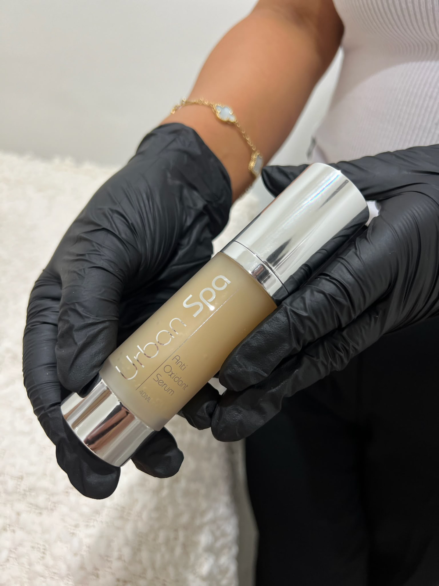 Clinician holding a professional antioxidant serum used in Derma Corner treatments