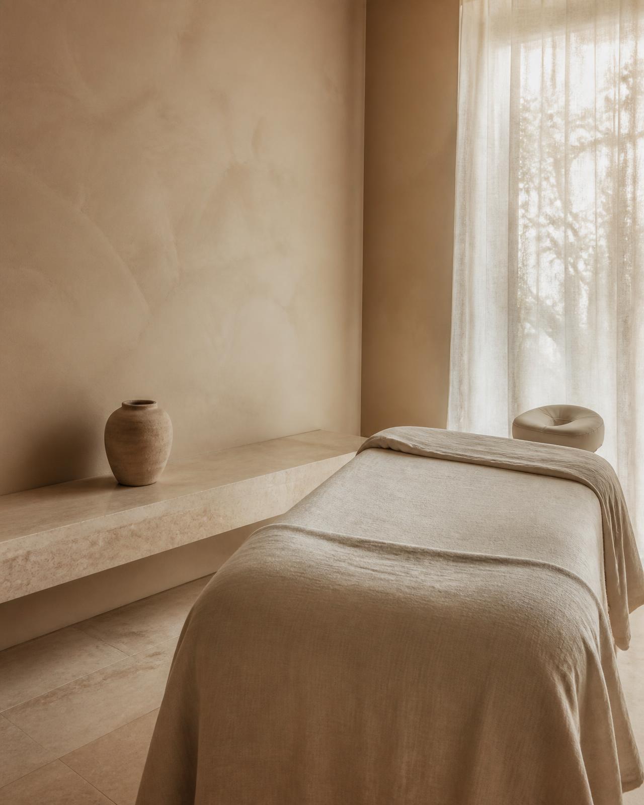 Calm treatment room with linen draping and warm daylight